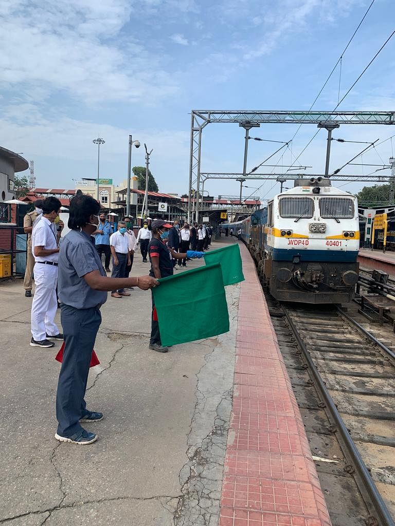 The cleaning staff flag off the train to Belagavi at 8 am on Friday. (Credit: DH Photo)