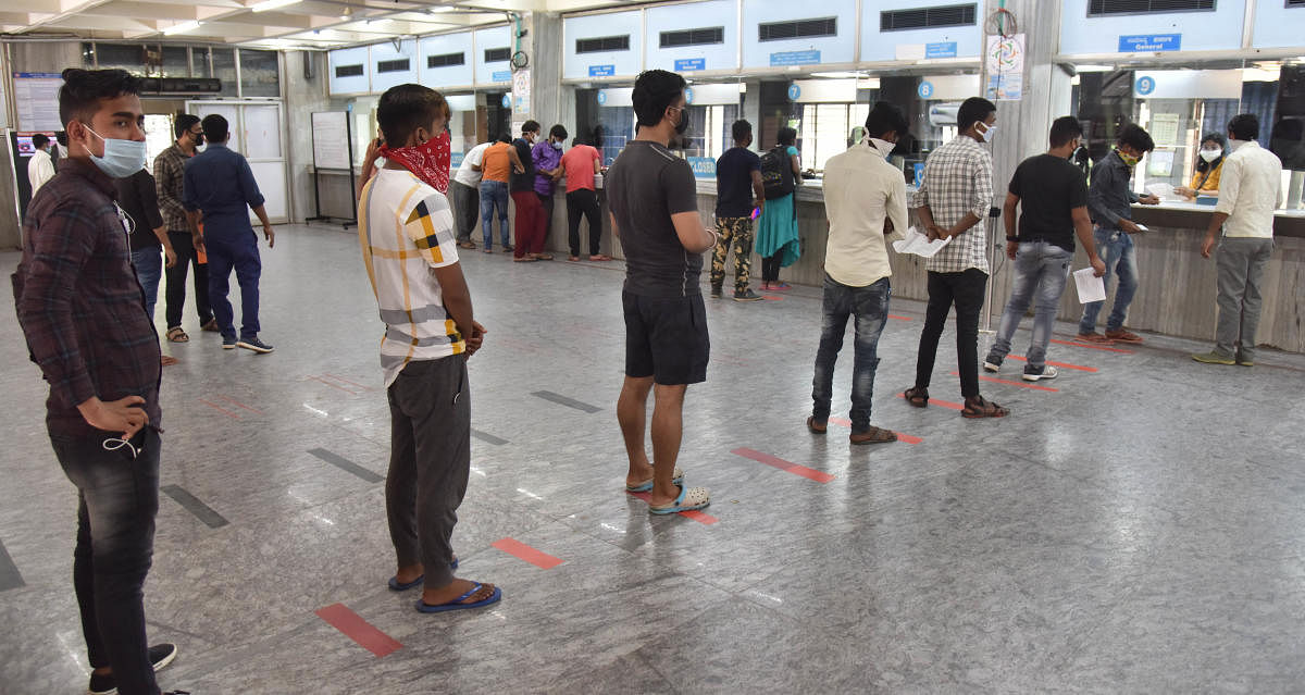 People waiting in a line in front of reservation counter for tickets at the KSR Railway station after lockdown loosen up in Bengaluru on Friday, 22 May 2020. Photo by Janardhan B K
