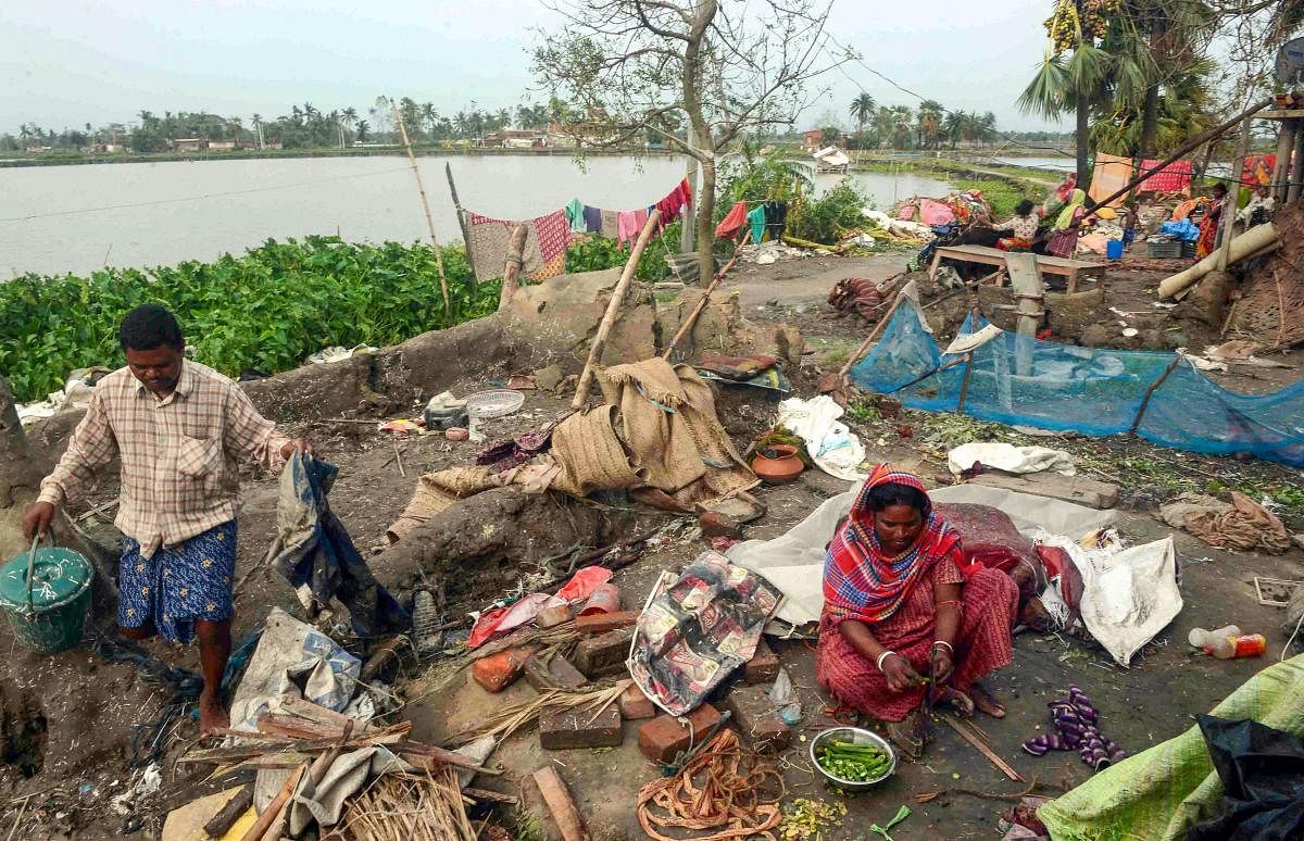A woman cooks food in a damaged house, in the aftermath of Cyclone Amphan, in South 24 Paraganas district of West Bengal, Friday, May 22, 2020. (PTI Photo)