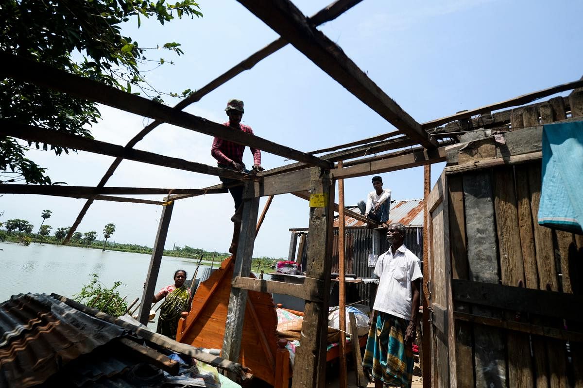 Villagers repair their house damaged by cyclone Amphan in Satkhira on May 22, 2020. AFP