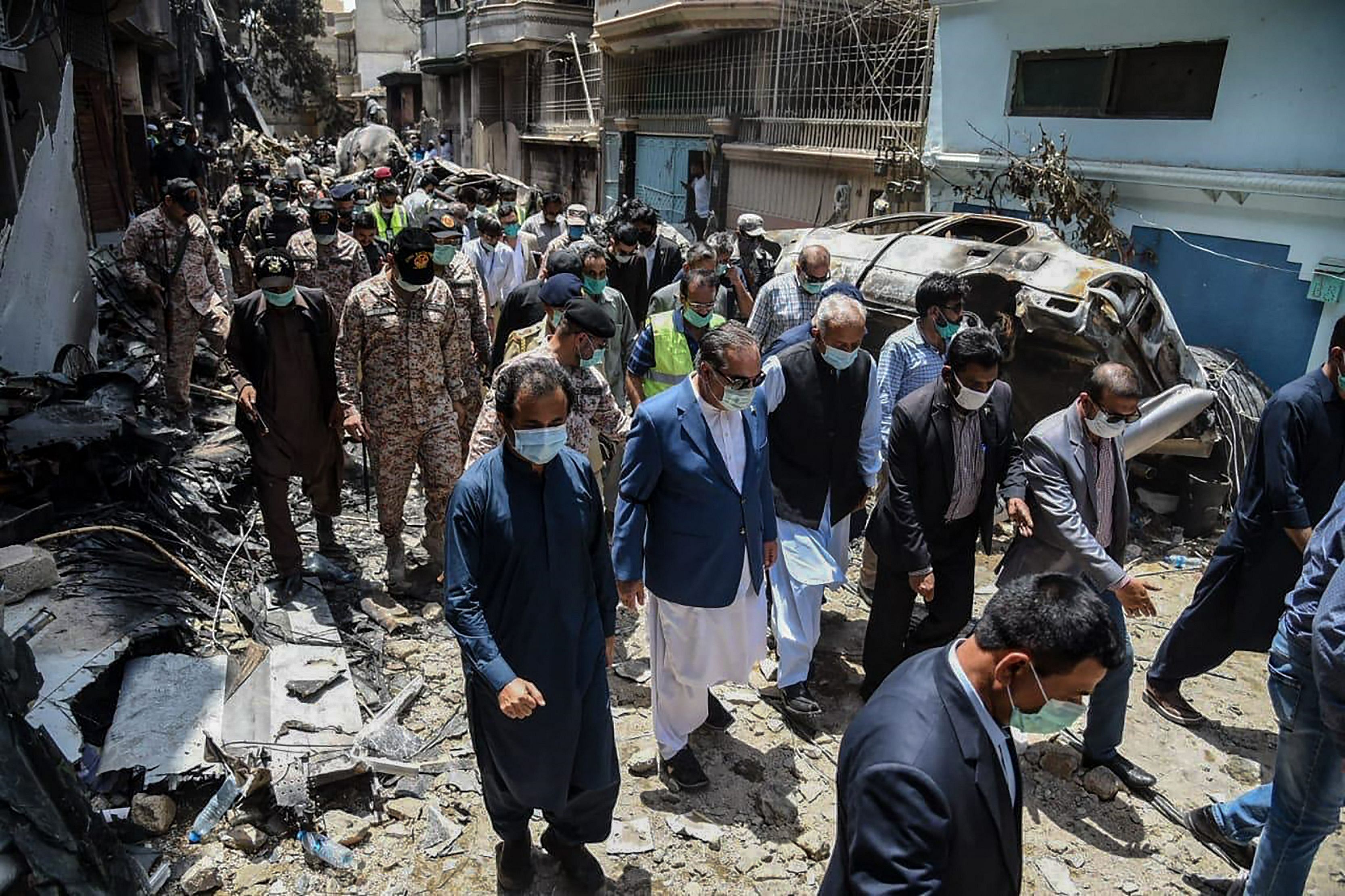 A PIA Airbus jet with 99 people aboard crashed into a crowded residential district of the city of Karachi on Friday afternoon after twice trying to land at the airport. (Credit: AFP Photo)