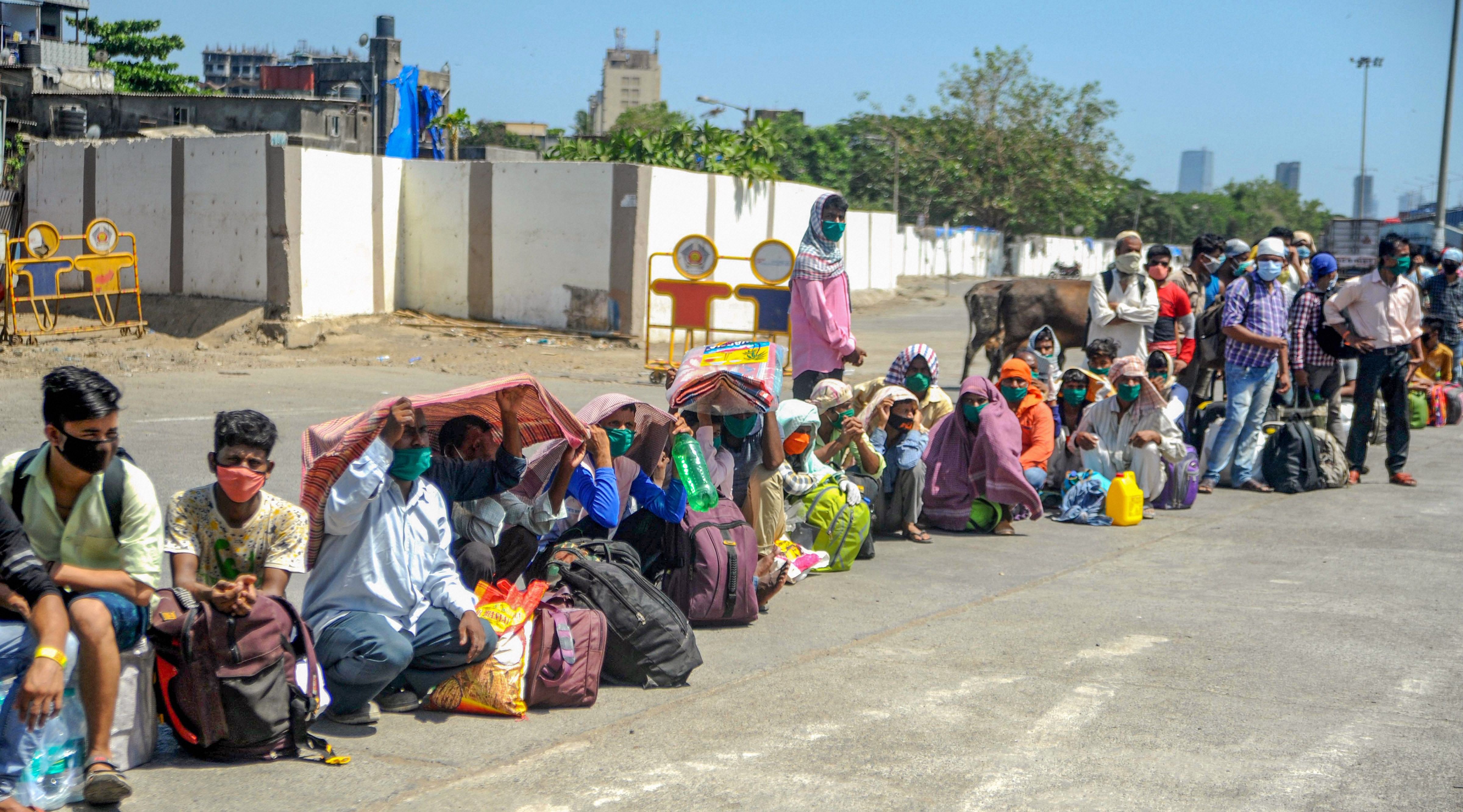 Migrants wait outside Bandra station as they wait to board a train to their native places, during the ongoing nationwide lockdown to curb the spread of coronavirus. (PTI Photo)