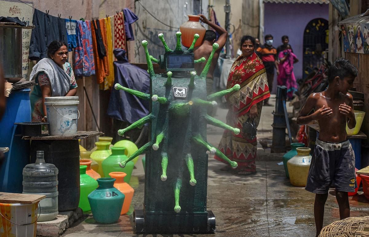  Residents watch the demonstration of a coronavirus-themed robot that sprays disinfectant in a residential area, during ongoing COVID-19 lockdown, in Chennai, Wednesday, May 20, 2020. (PTI Photo)