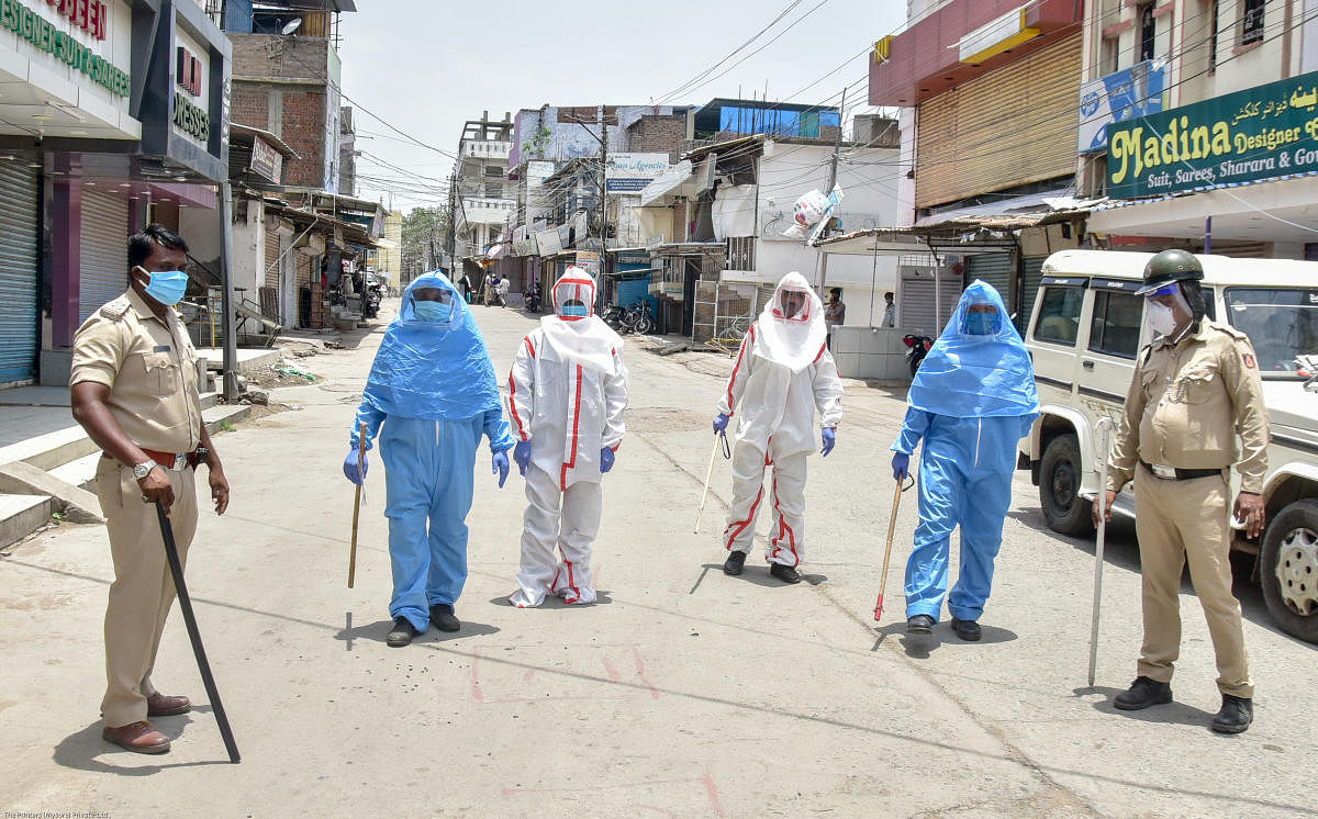 A file photo of policemen and Home Guards in protective gear at a containment zone in Kalaburagi. DH Photo