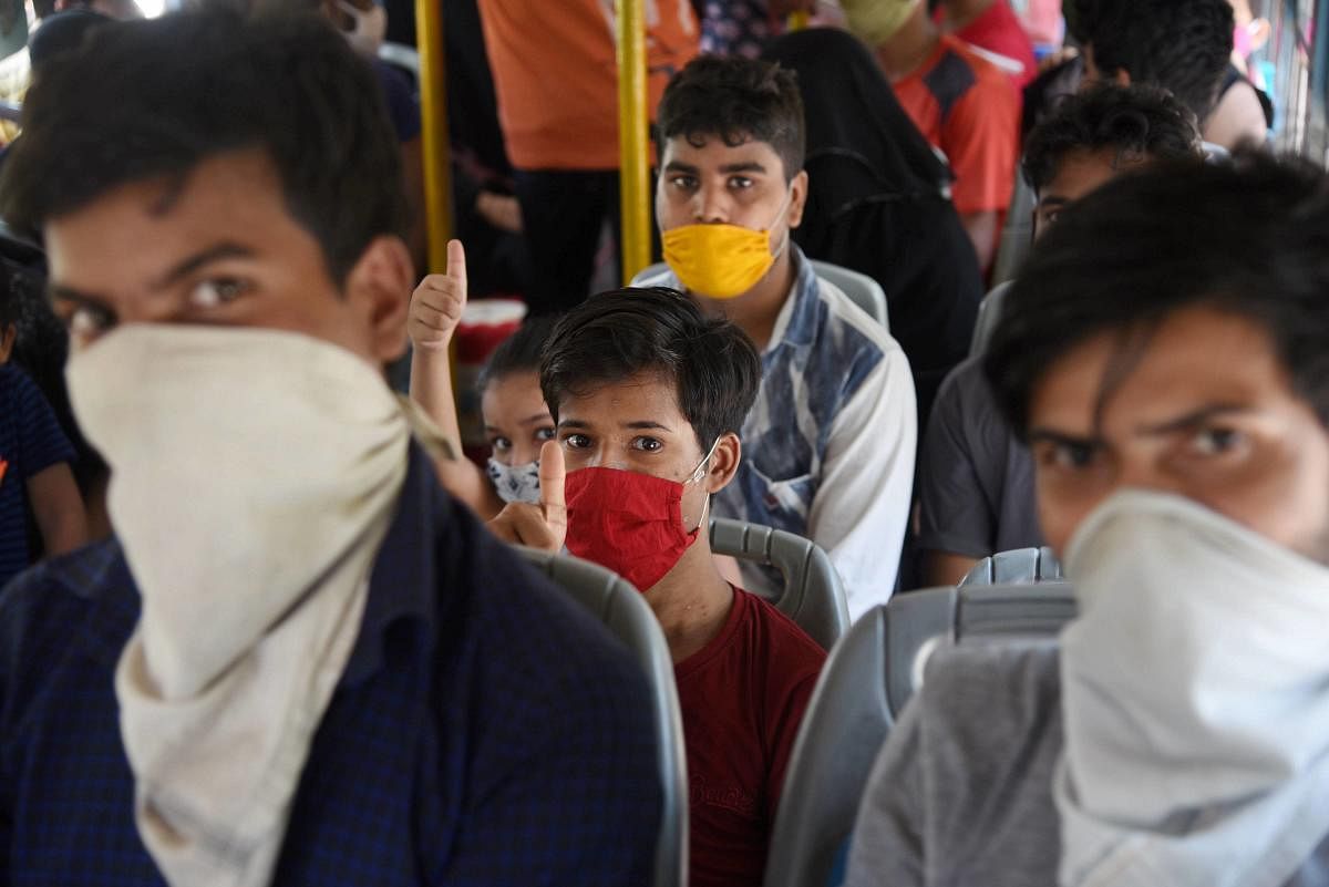 Migrant workers from Bihar board a bus for Panvel Railway Station, during the ongoing COVID-19 nationwide lockdown, Saturday, May 23, 2020. (PTI Photo)