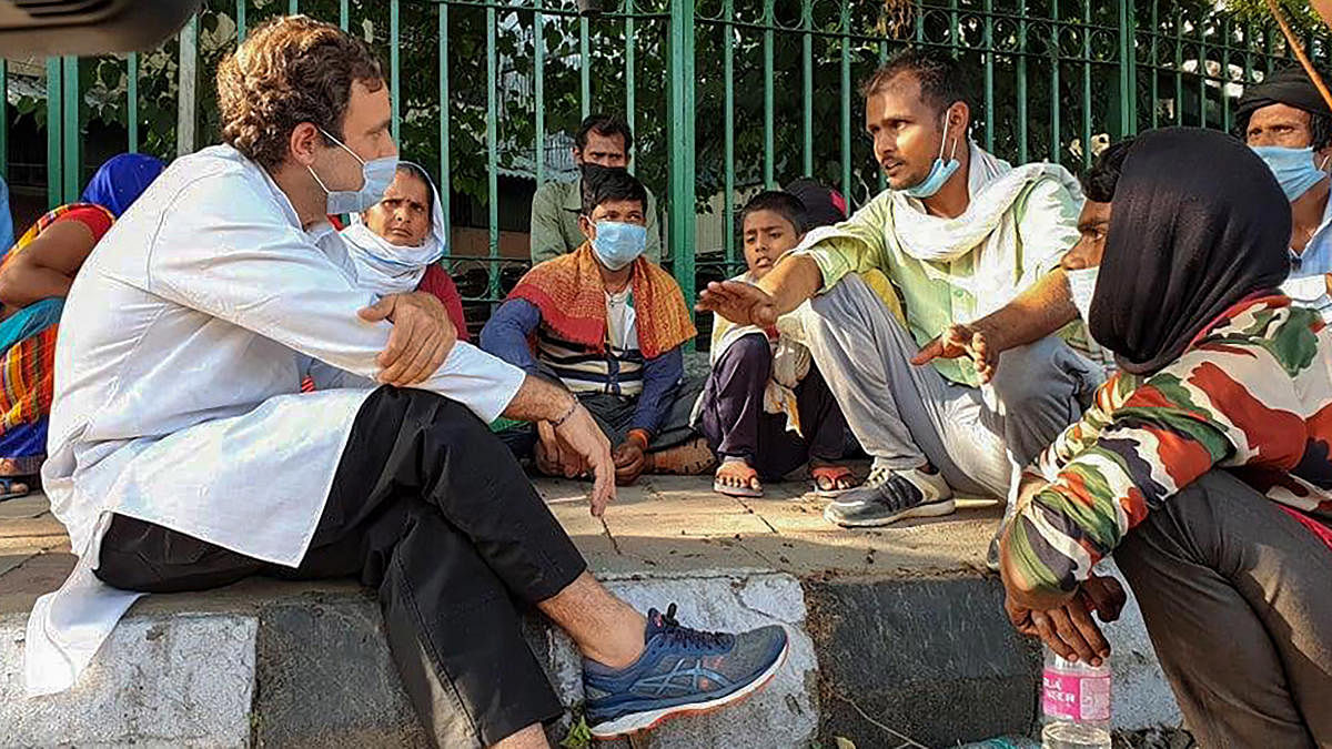 Former Congress president Rahul Gandhi interacts with migrant labourers who were walking on the Sukhdev Vihar flyover to reach their native places, amid ongoing COVID-19 lockdown (PTI Photo)