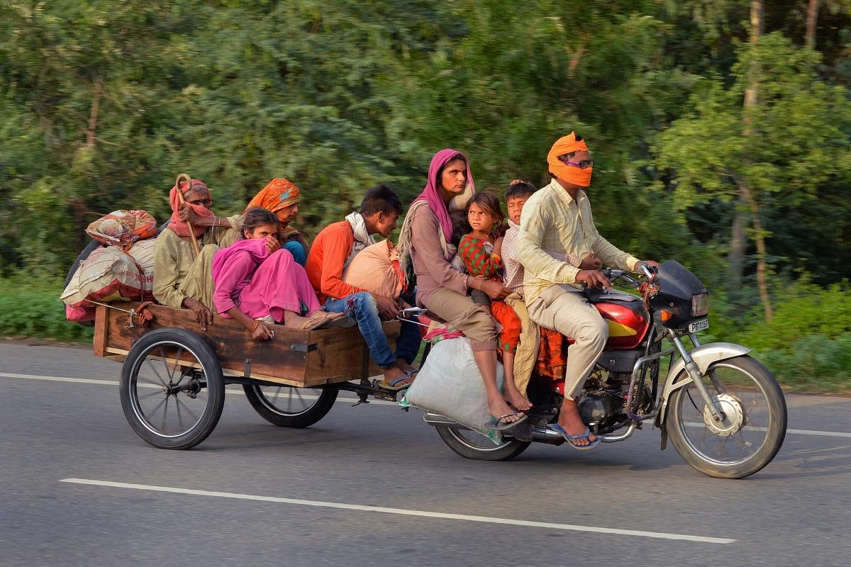  A migrant family rides a motor cart to reach their native place in Rajasthan, during the ongoing COVID-19 lockdown, on National Highway 44 in Karnal district, Sunday, May 17, 2020. (PTI Photo)