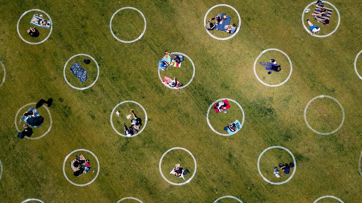  An aerial view shows painted circles in the grass to encourage people to social distance at Washington Square Park in San Francisco, California, on May 22, 2020, amid the novel coronavirus pandemic. Credit: AFP Photo