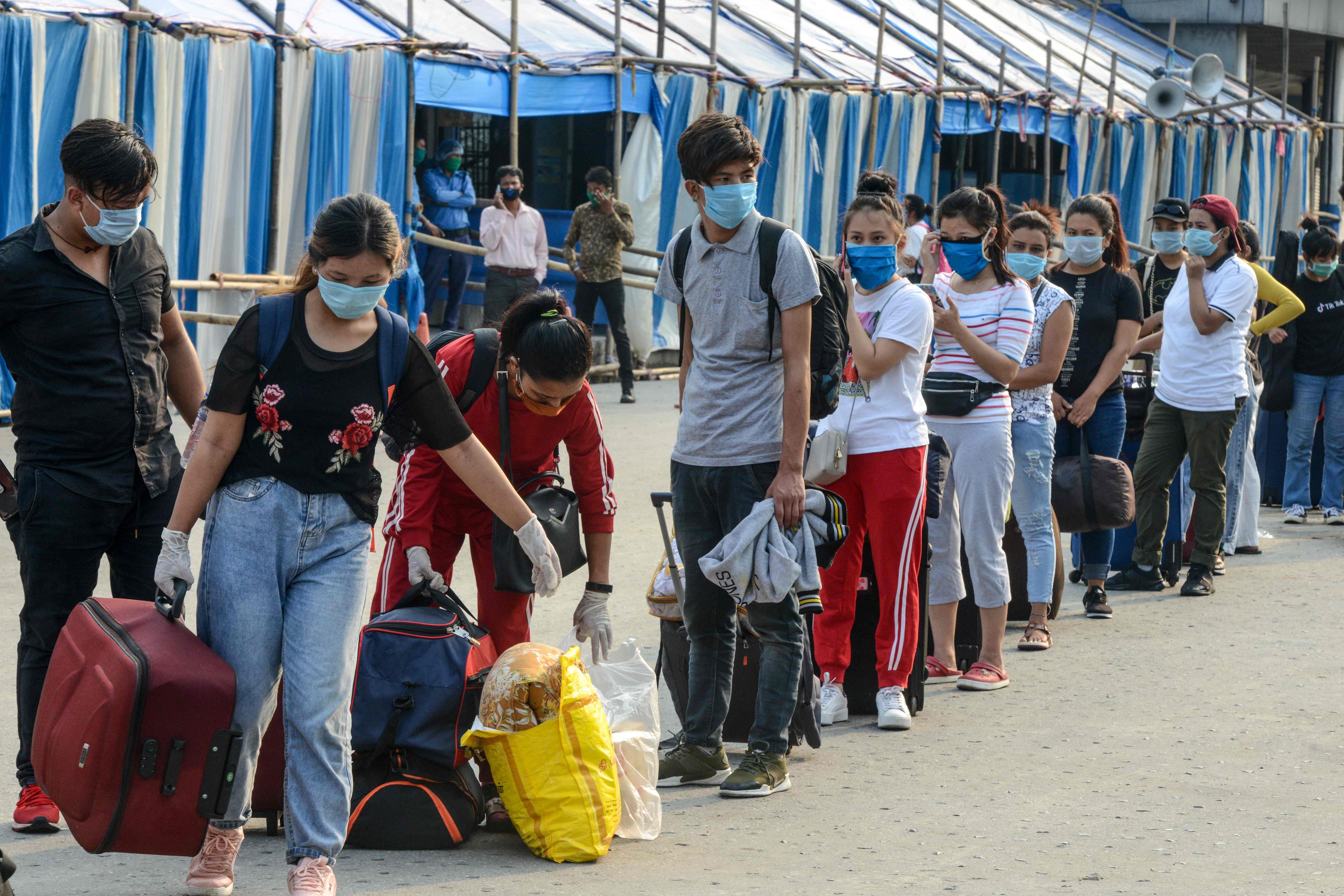Migrant passengers from Sikkim state wait for transportation after they arrived from Chennai. (AFP Photo)