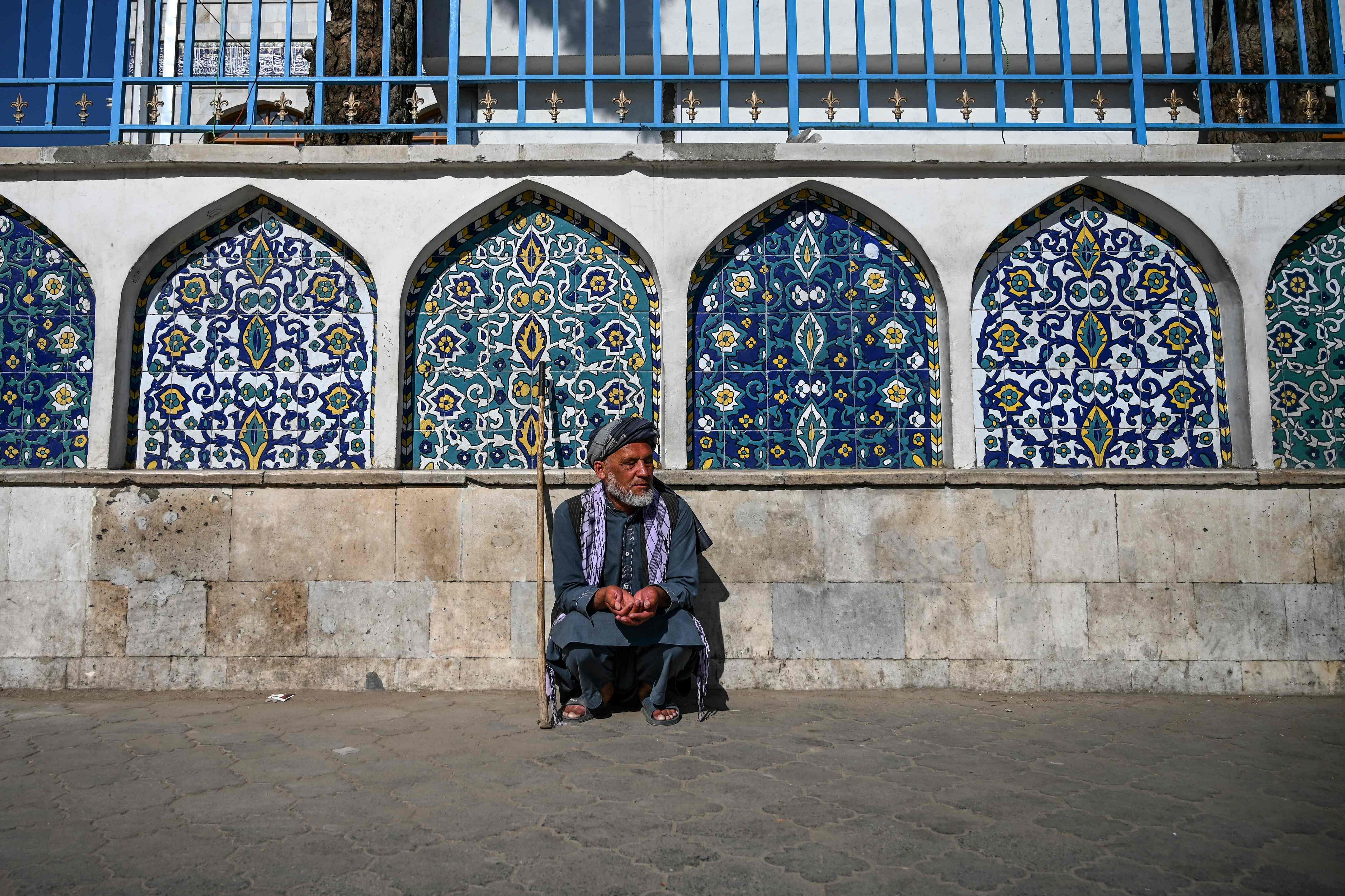 A man sits outside the Pul-e Khishti mosque at the start of the Eid al-Fitr festival which marks the end of the Muslim holy month of Ramadan in Kabul  (Credit: AFP Photo)