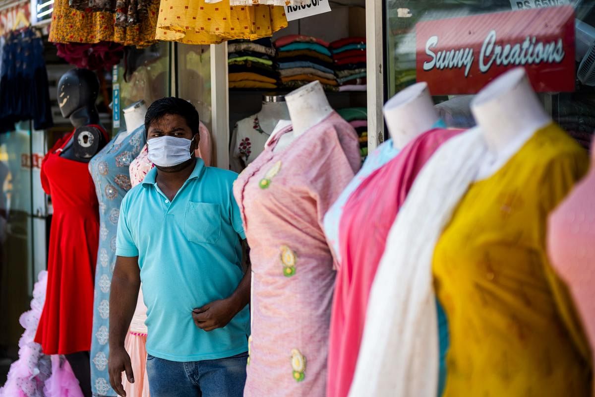 An employee waits for customers in front of a clothing store in a market after the government eased a lockdown imposed as a preventive measure against the spread of the COVID-19 (AFP Photo)