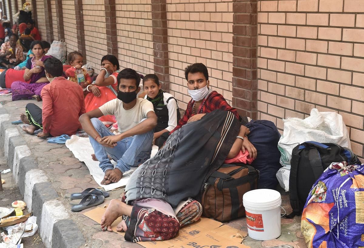  Migrants sit on a pavement outside a government school  during the ongoing COVID-19 lockdown, in New Delhi (PTI Photo)