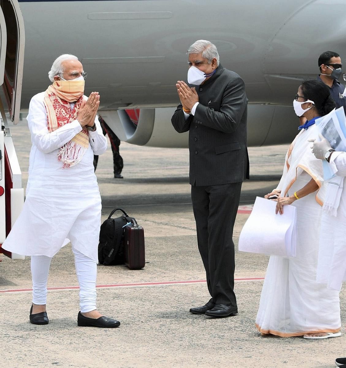 Prime Minister Narendra Modi being received by West Bengal Governor Jagdeep Dhankar and Chief Minister Mamata Banerjee on his arrival at the airport to take stock of the situation in the state after Cyclone Amphan, in Kolkata. (PTI file photo)