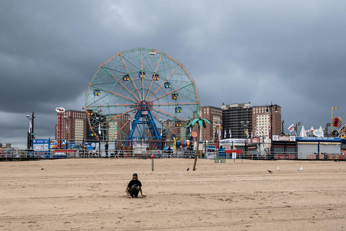 A boy wearing a protective mask is seen on the Coney Island beach ahead of Memorial Day following the outbreak of the coronavirus disease (COVID-19) in Brooklyn, New York City. (Reuters photo)