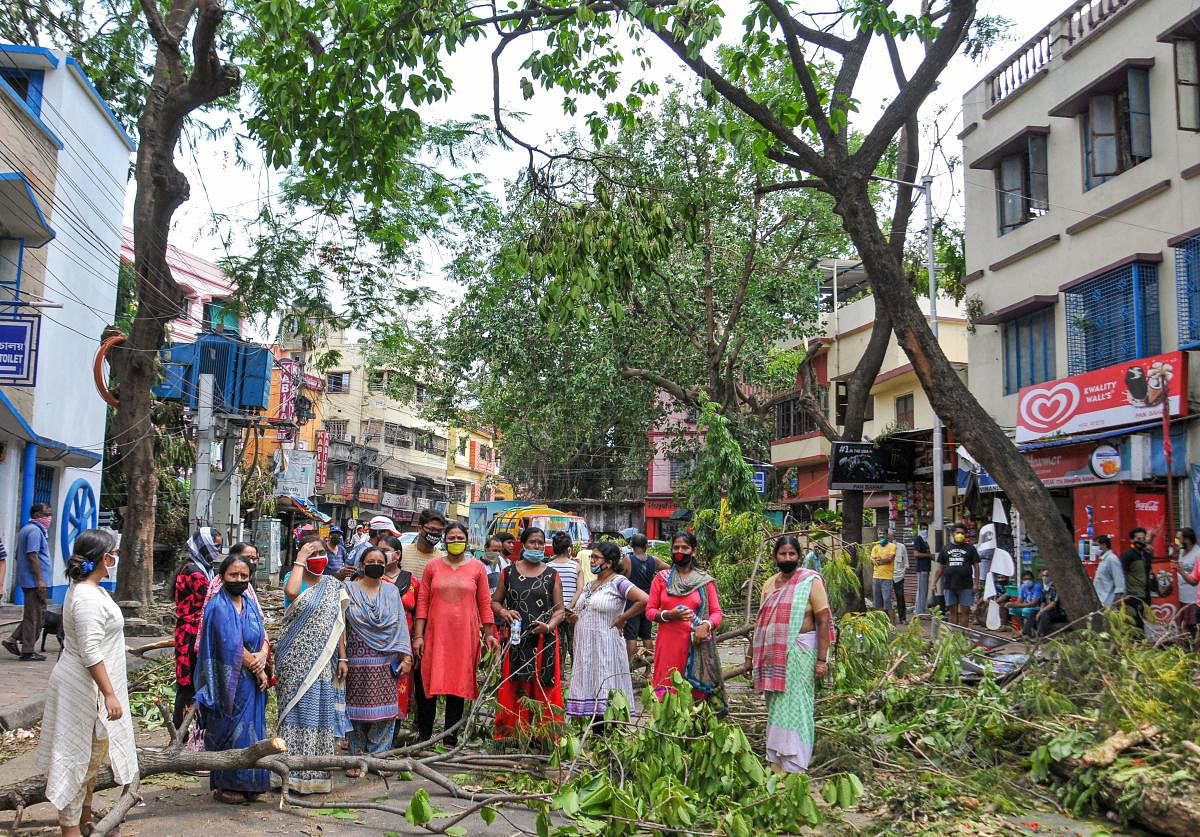  Women block a road to protest against the delay of removing uprooted trees, prolonged power cuts and unavailability of water, in the aftermath of super cyclone 'Amphan', at Bijoygarh area in Kolkata, Saturday, May 23, 2020. (PTI Photo)