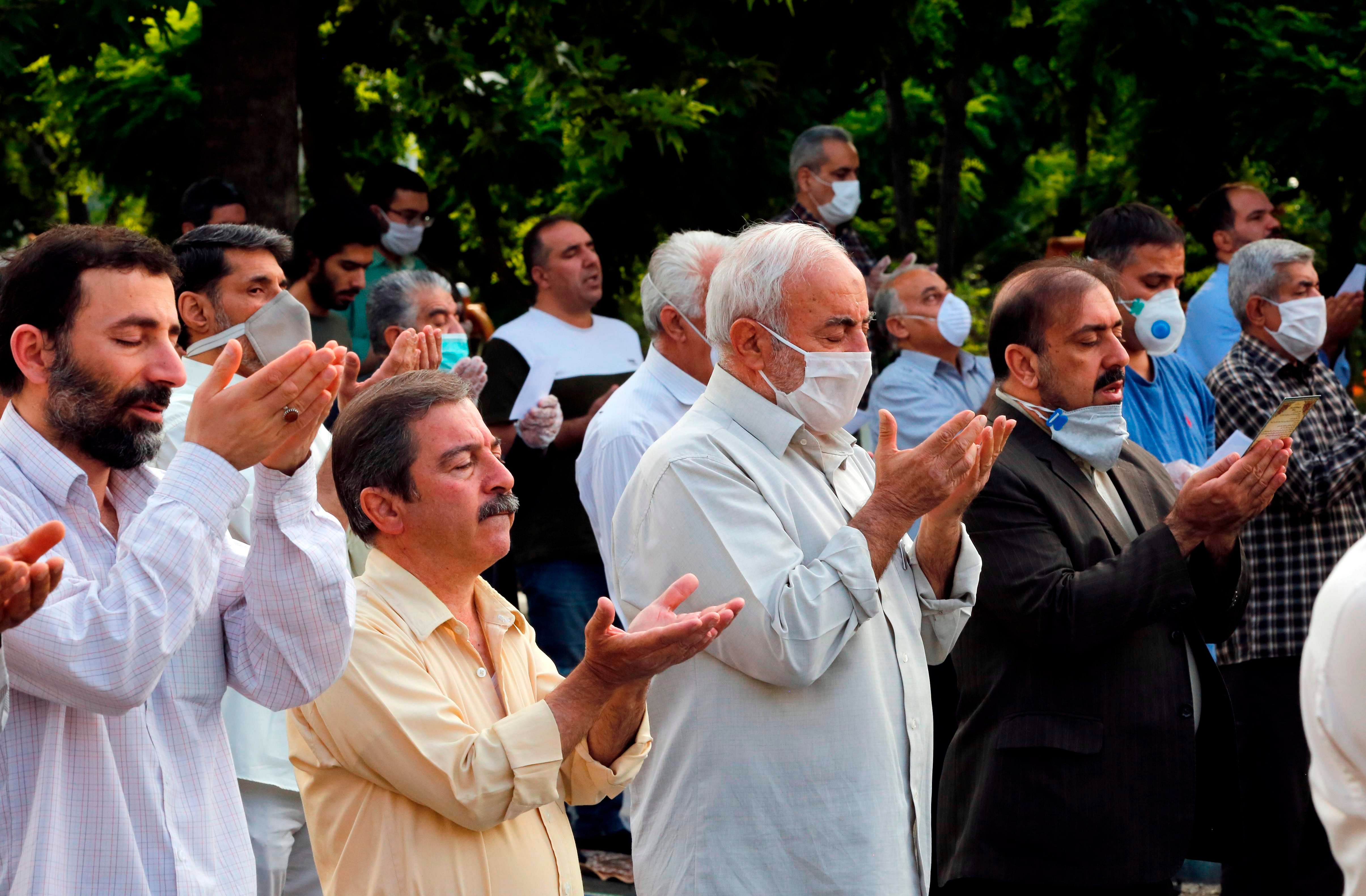 Muslim worshippers, standing spaced from each other with some clad in masks as a measure against the COVID-19 coronavirus pandemic. (AFP Photo)