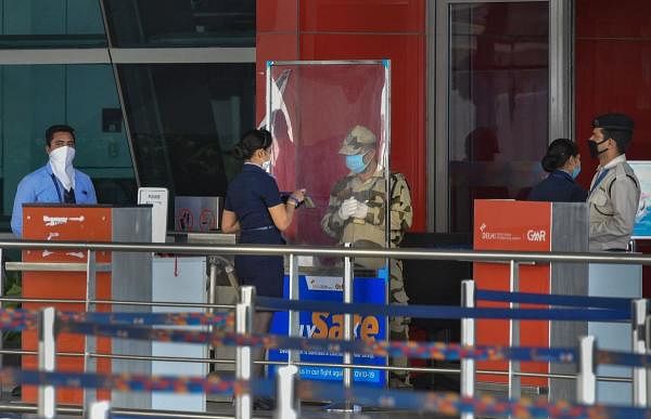  A flight attendent shows her ID card outside T3 deparature gate of Indira Gandhi International Aiport, during the fourth phase of COVID-19 nationwide lockdown, in New Delhi, Sunday, May 24, 2020. (Credit: PTI Photo)