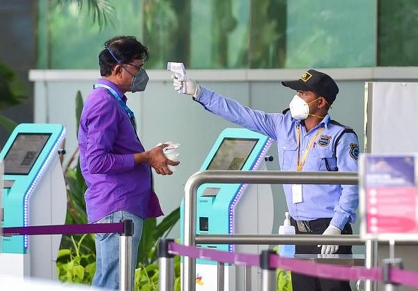 A airport staff being screened outside Kempegowda International Airport, amid the ongoing nationwide COVID-19 lockdown, in Bengaluru, Sunday, May 24, 2020. (Credit: PTI Photo)