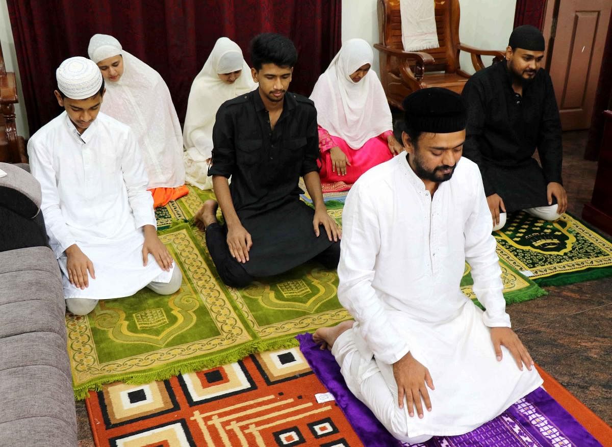 A family offers prayers at their home in KHB Colony, as part of Ramzan festival, in Hassan on Monday. DH PHOTO