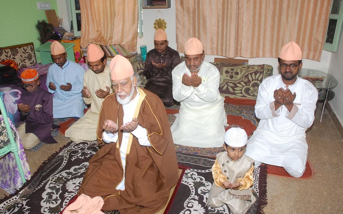 Members of a family offer prayers together at their house as part of Eid ul-Fitr due to lockdown in Kolar on Monday.