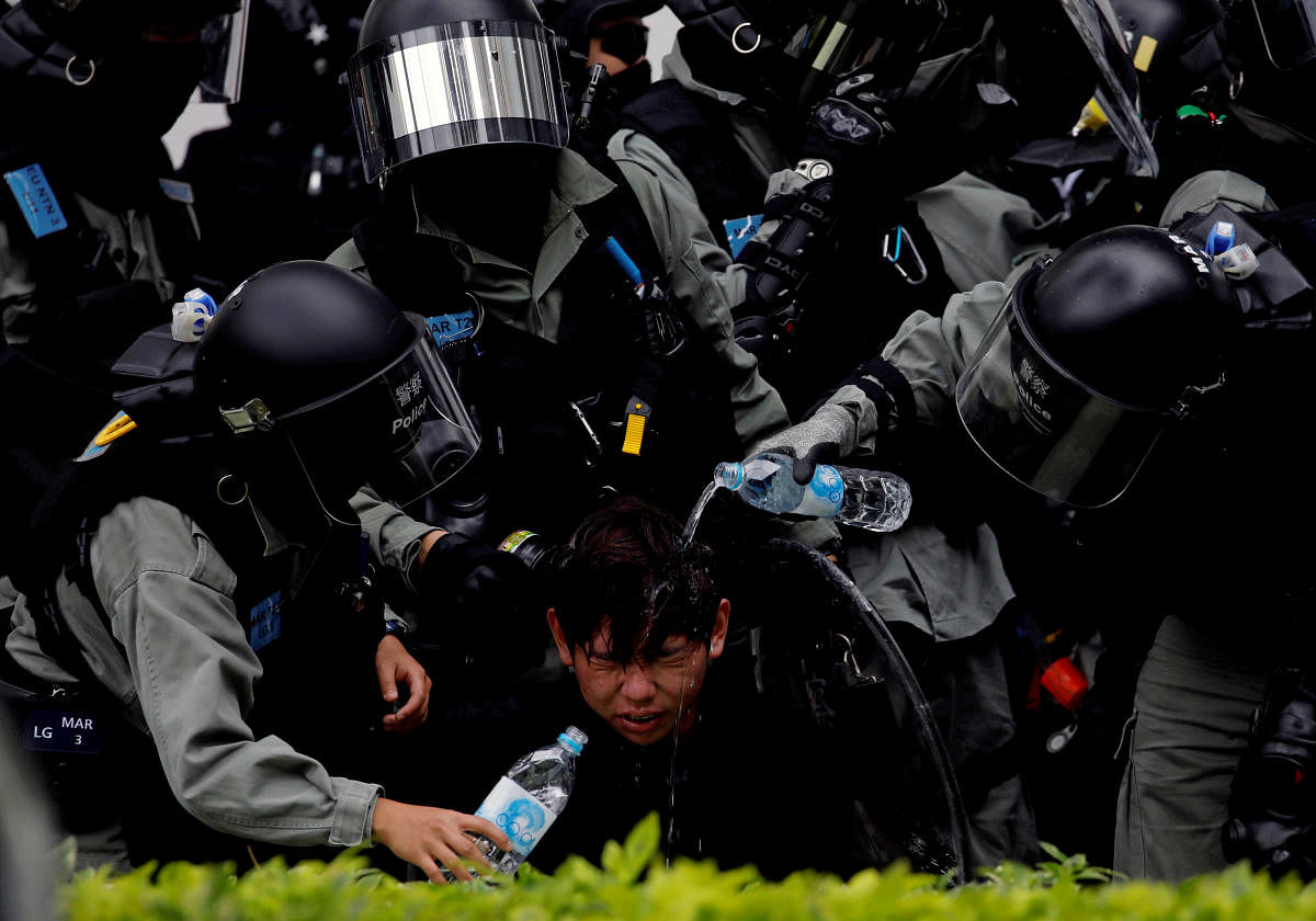Riot police pour water on the face of anti-government protester after an anti-parallel trading protest at Sheung Shui, a border town in Hong Kong. Reuters