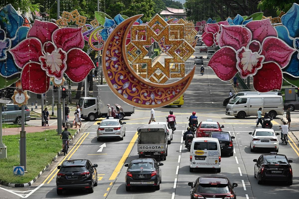 Motorists ply along the road decorated with festive displays ahead of Eid al-Fitr which marks the end of the Muslim holy month of Ramadan, at the Geylang Serai market in Singapore. AFP