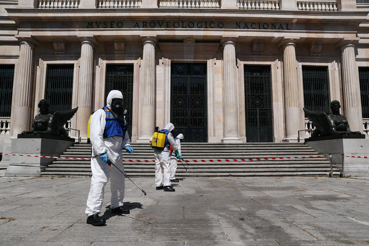 Members of the Spanish Emergency Military Unit (UME) wearing full personal protective equipments disinfect outside the Archaeological Museum amid the coronavirus disease (COVID-19) outbreak, in Madrid, Spain May 25, 2020. Credit: Reuters File Photo