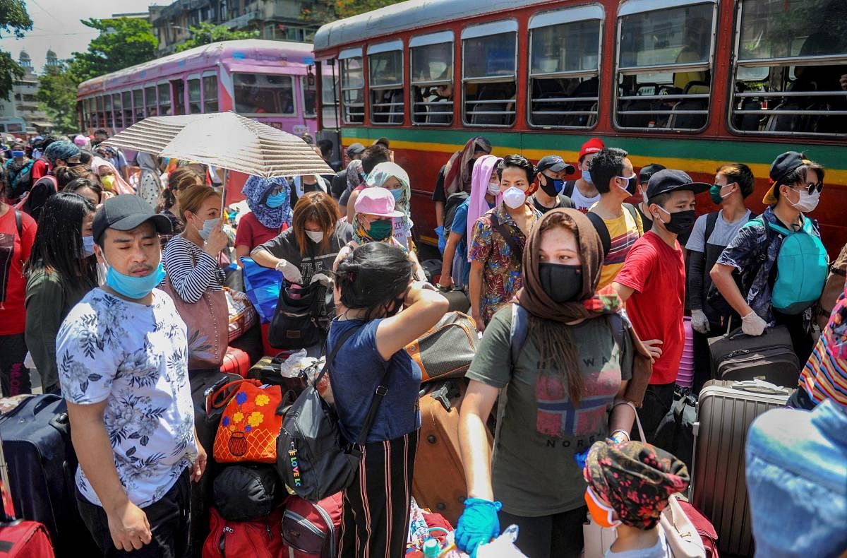 People from Manipur and other parts of northeast board buses at Kalina Santacruz to reach Chhatrapati Shivaji Maharaj Terminus for their onward journey by a special train to their native places, during ongoing COVID-19 lockdown in Mumbai, Thursday, May 21, 2020. (PTI Photo) 