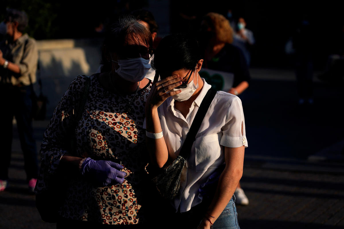 Relatives of a patient who suffers from COVID-19 react, as staff members from La Paz hospital attend a protest to ask for more health personnel in hospitals, primary care and nursing homes, amid the coronavirus disease (COVID-19) outbreak in Madrid, Spain, May 25, 2020. Credit: Reuters Photo