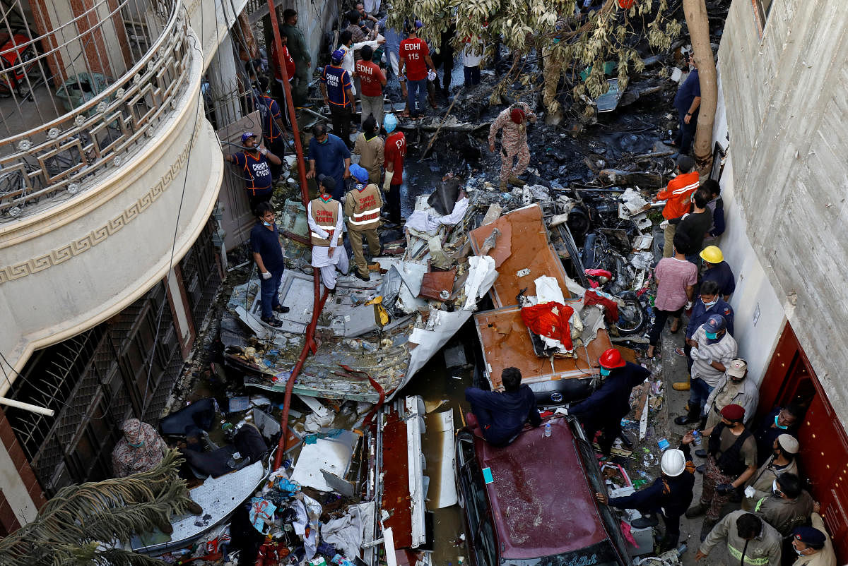 Rescue workers gather at the site of a passenger plane crash in a residential area near an airport in Karachi, Pakistan. (Reuters photo)