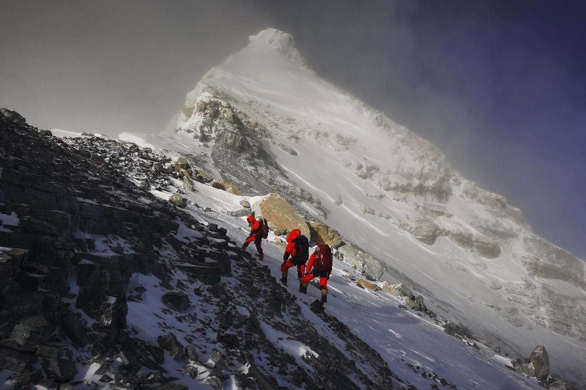 In this photo released by Xinhua News Agency, members of a Chinese surveying team head for the summit of Mount Everest, also known locally as Mt. Qomolangma, Wednesday, May 27, 2020. (AP Photo)