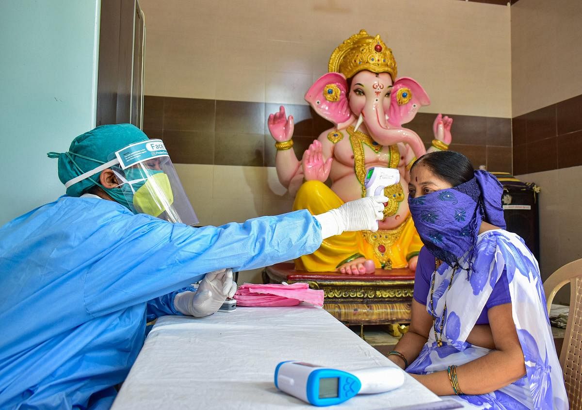  Medics conduct screening of residents at a camp, in wake of the coronavirus pandemic, during the ongoing nationwide lockdown, at a containment zone, in Solapur, Wednesday, May 27, 2020. (PTI Photo)