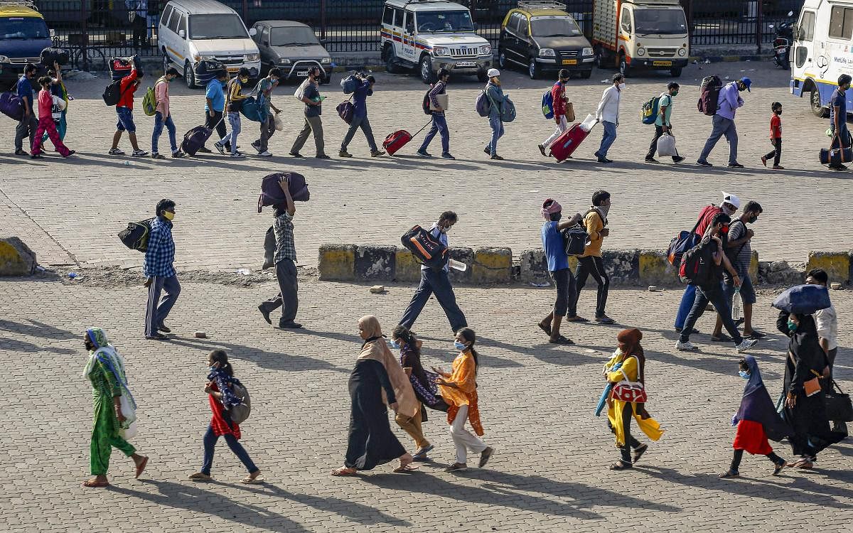  Migrants walk to Lokmanya Tilak Terminus to catch a special train to reach their native places, during ongoing COVID-19 lockdown, in Mumbai, Tuesday, May 26, 2020. (PTI Photo)
