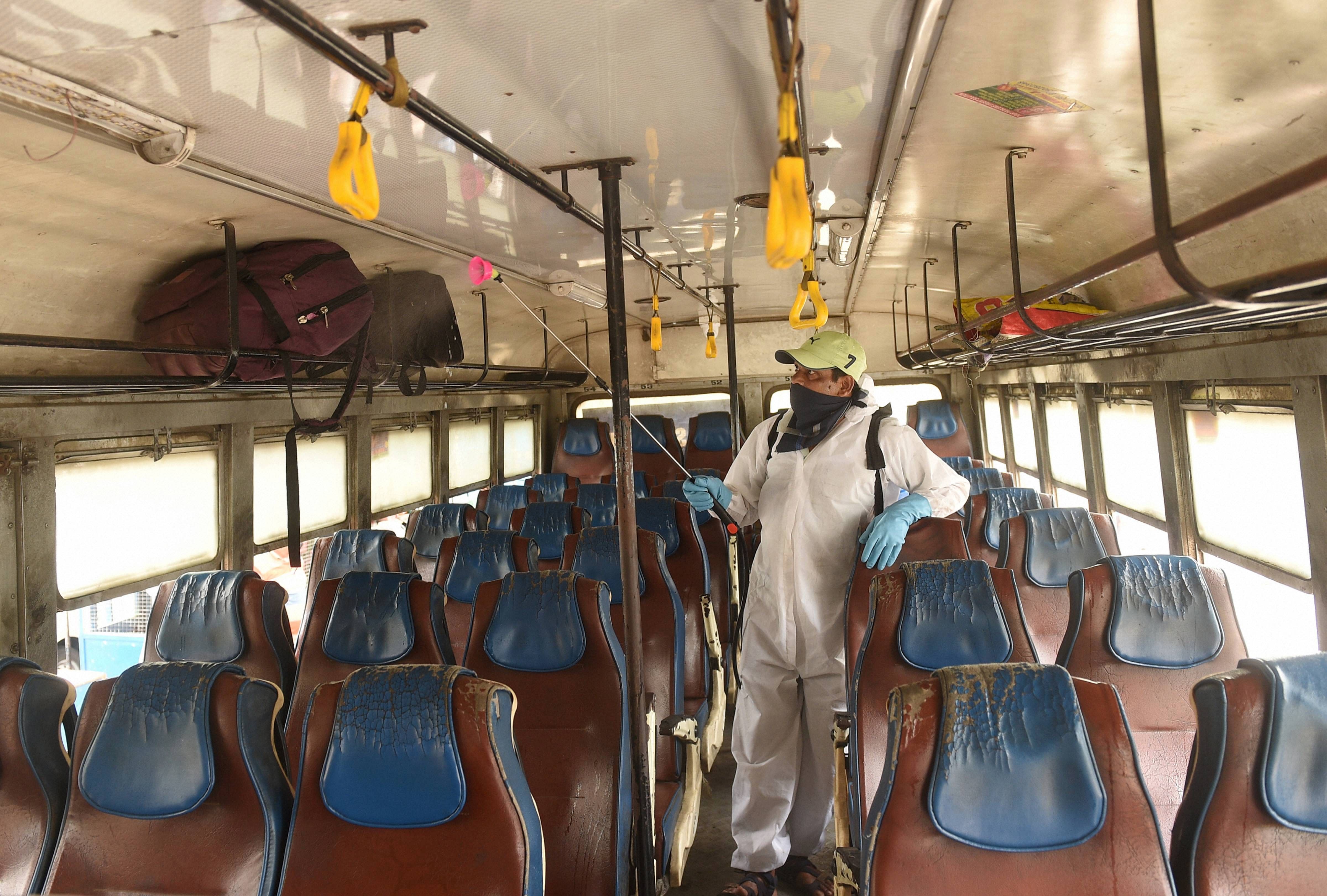 A health worker sanitizes a public bus after the authorities permitted to start the interstate bus service, during the ongoing COVID-19 nationwide lockdown, in Kolkata, Wednesday, May 27, 2020. (PTI Photo)