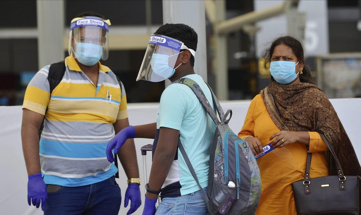 Passengers wearing face shields upon their arrival at T3 of IGI airport after the resumption of flight services, in New Delhi, Tuesday, May 26, 2020. Credit: PTI Photo