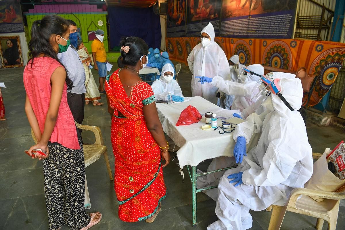 Doctors and medical staff attend residents at a COVID-19 coronavirus community clinic during a nationwide lockdown imposed as a preventive measure against the COVID-19 coronavirus, in Mumbai on May 19, 2020. (AFP)