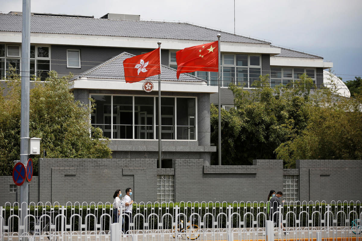  Chinese and Hong Kong flags at the office of the Government of the Hong Kong Special Administrative Region in Beijing, China. (REUTERS Photo)