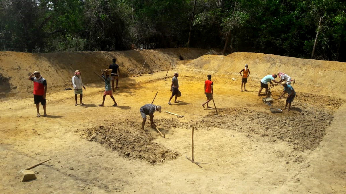 Youths removing the silt of a lake at Kaduru.