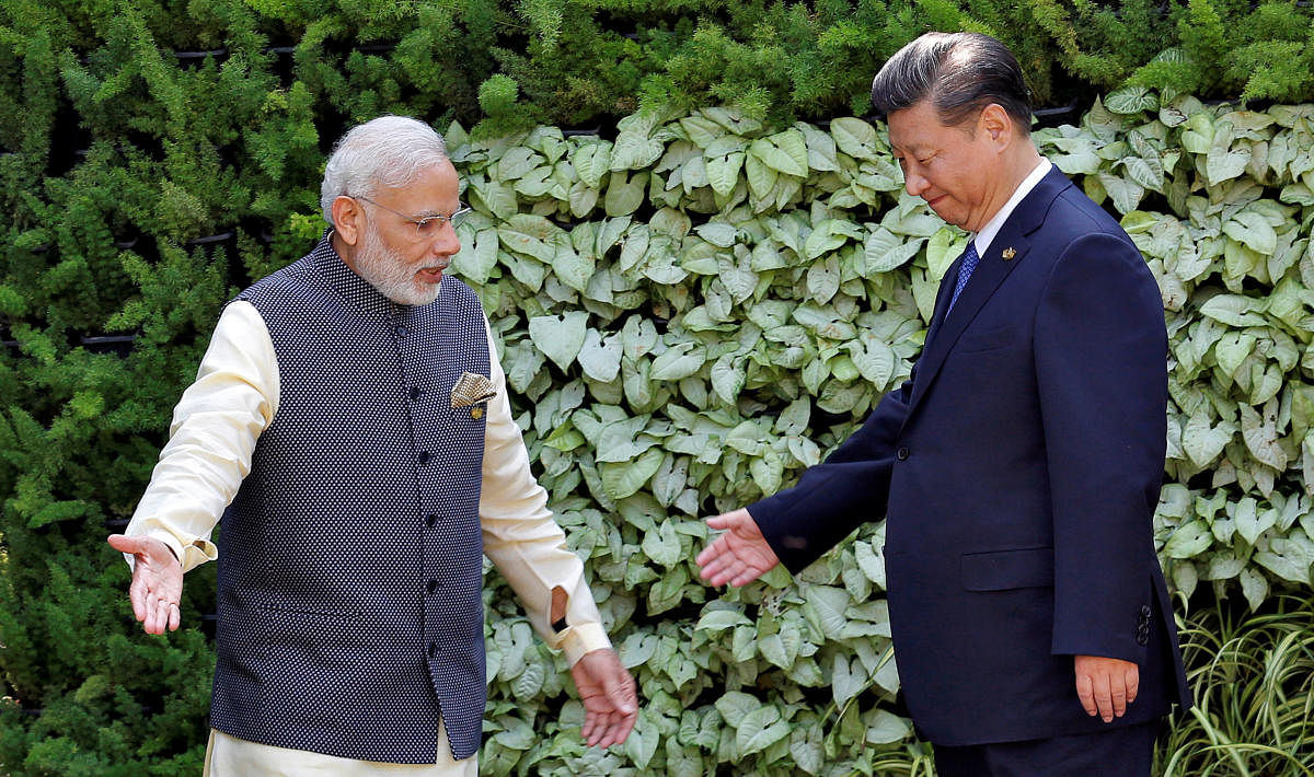  Indian Prime Minister Narendra Modi and Chinese President Xi Jinping leave after a group picture during BRICS (Brazil, Russia, India, China and South Africa) Summit in Benaulim. Credit: Reuters Photo