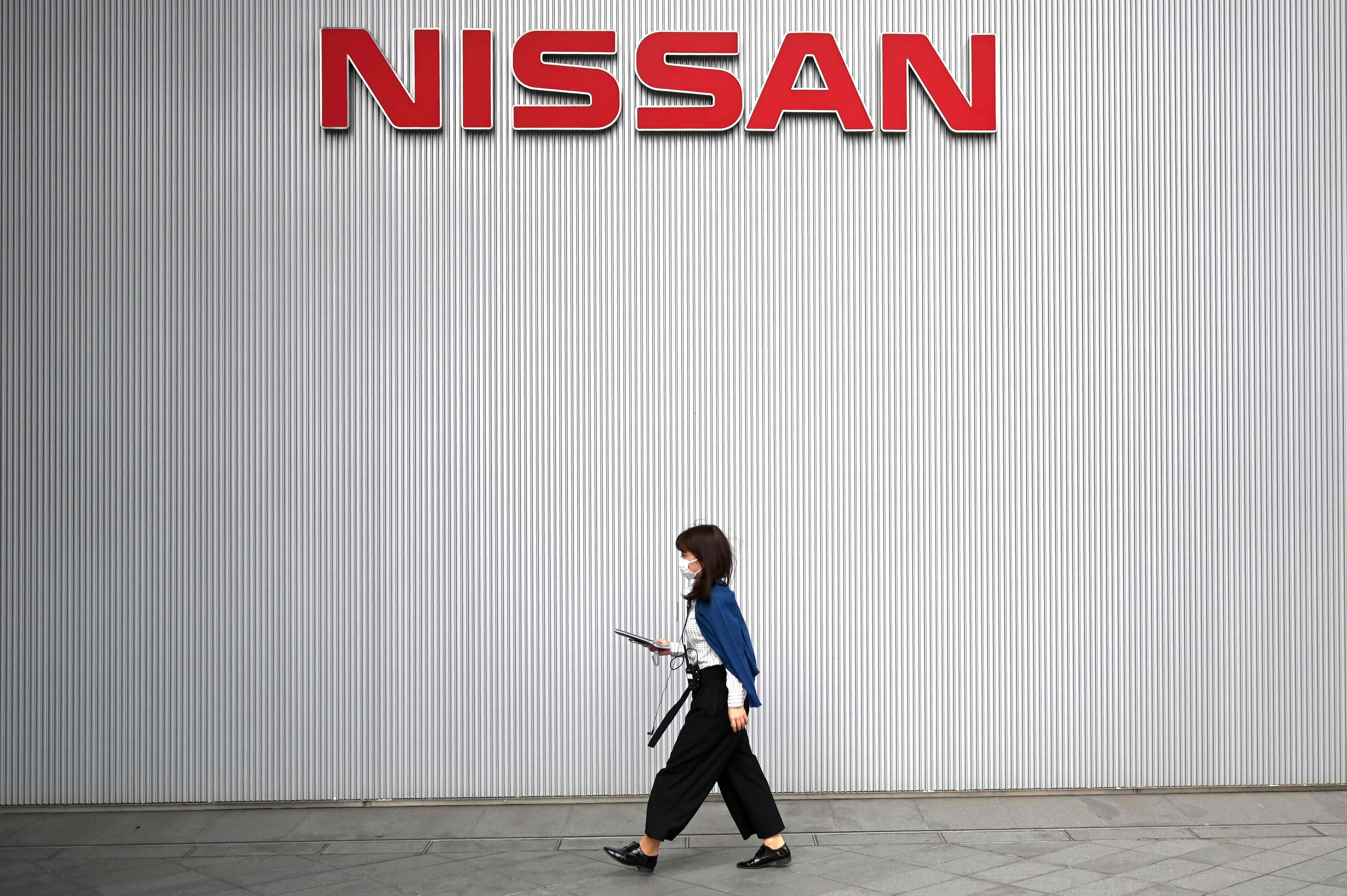 A woman walks around the Nissan Motor Corporation headquarters in Yokohama. (AFP Photo)