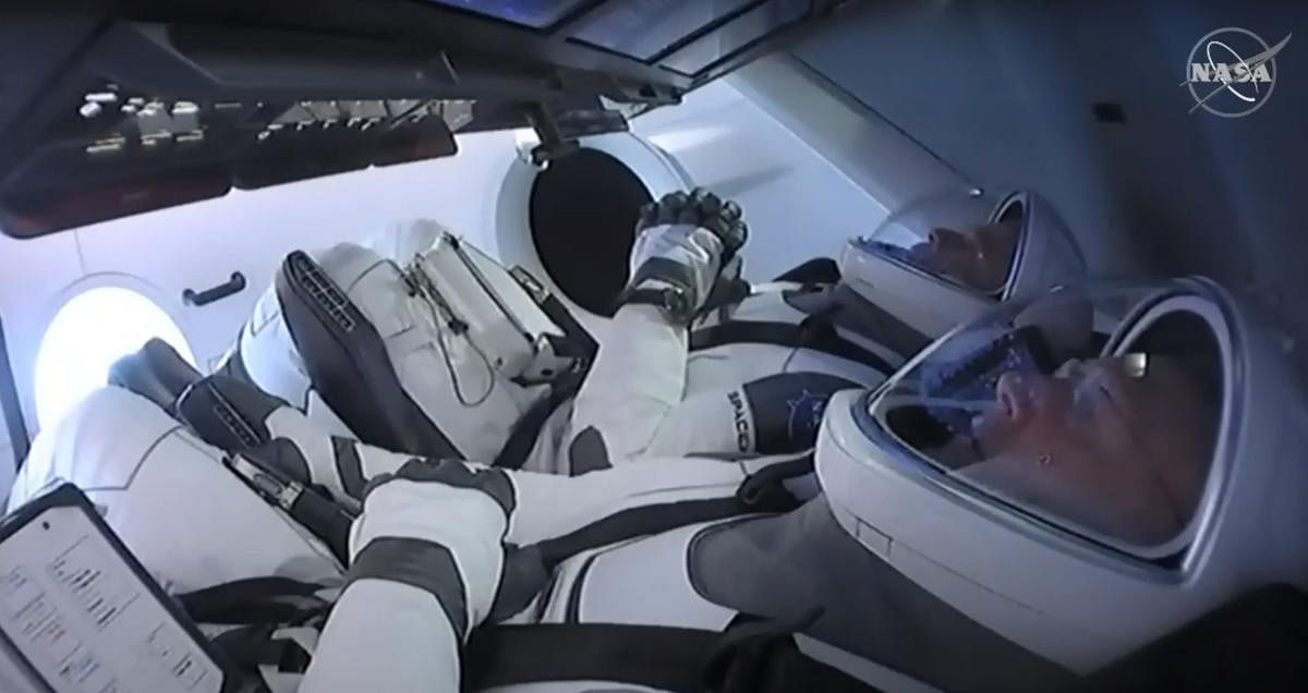 This still image taken from NASA TV, shows the SpaceX Crew Dragon capsule, with astronauts Bob Behnken (front) and Doug Hurley, at Launch Complex 39A in Kennedy Space Center in Florida on May 27, 2020. Credit: AFP Photo