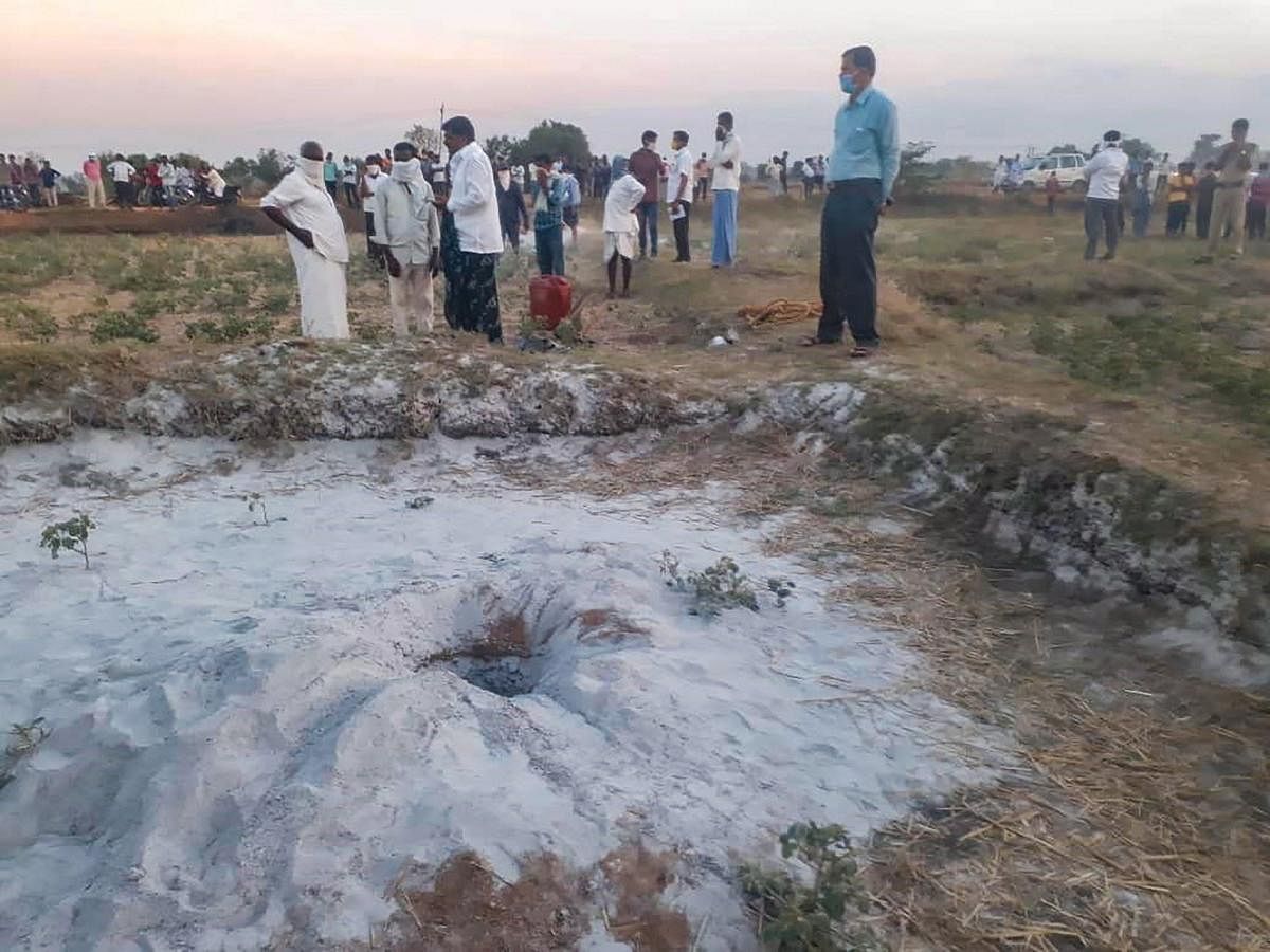 Villagers and officials at a site where a three-year-old boy slipped into a borewell while playing near it at Podechenpally village in Medak district, Wednesday evening, May 27, 2020. (PTI Photo)
