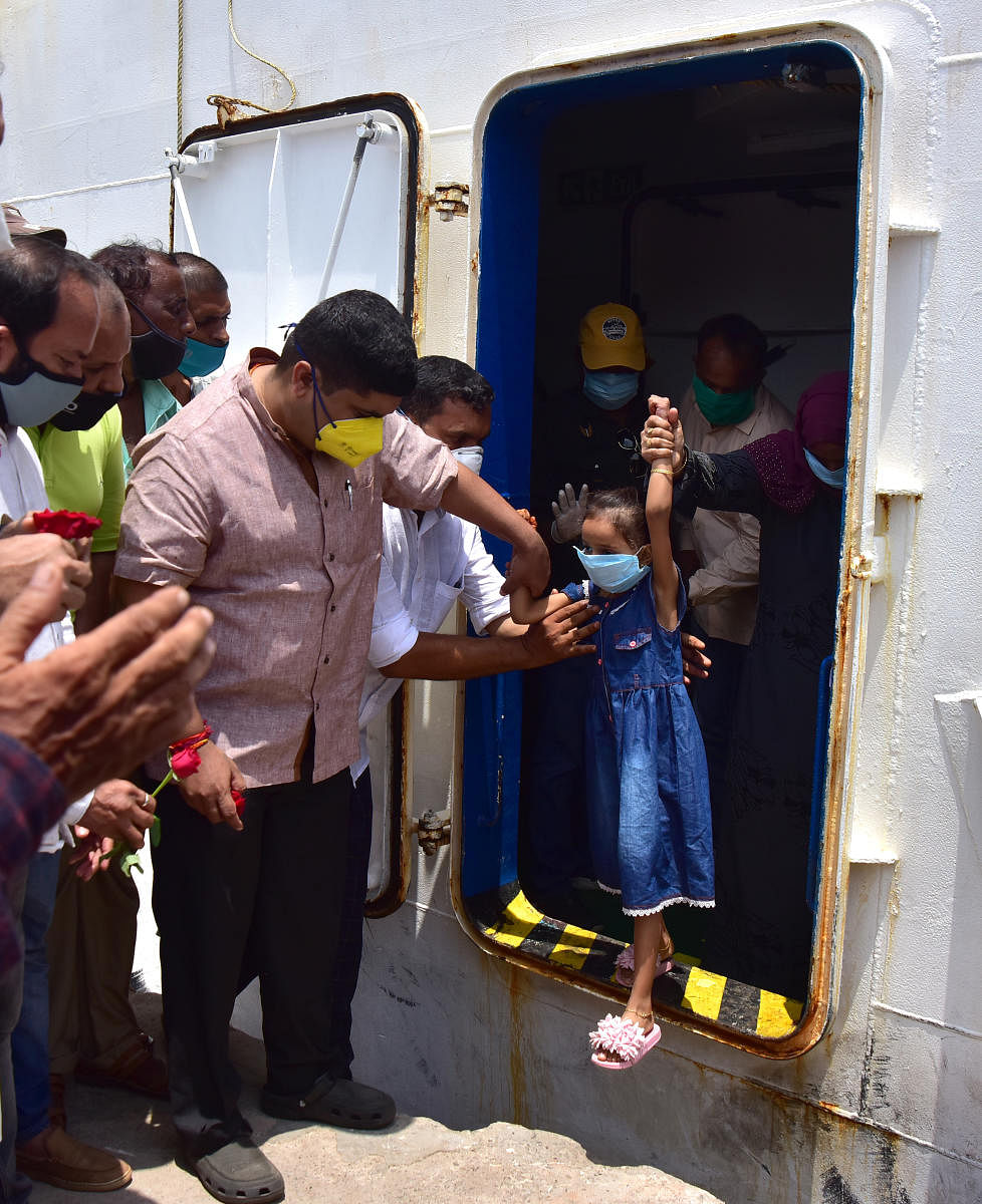 Mangaluru South MLA D Vedavyas Kamath seen helping a child alight from the boat at Old Port in Bunder on Thursday.
