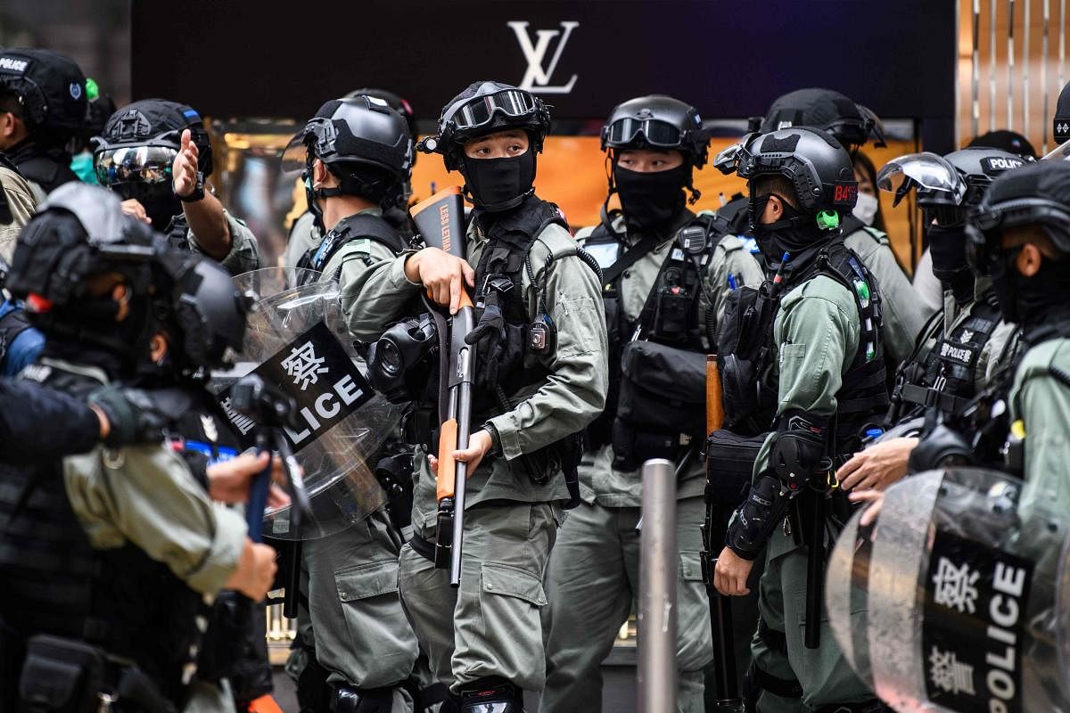 Riot police take part in a crowd dispersal operation in the Central district of Hong Kong on May 27, 2020, as the city's legislature debates over a law that bans insulting China's national anthem. AFP