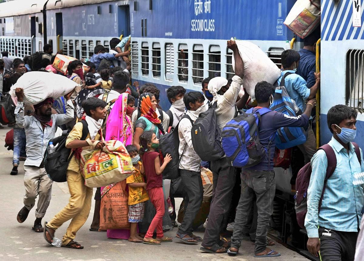 Migrants board 'Shramik Special' train at Danapur railway station to reach their native places, during the ongoing COVID-19 lockdown, in Patna, Wednesday, May 20, 2020. (PTI Photo)