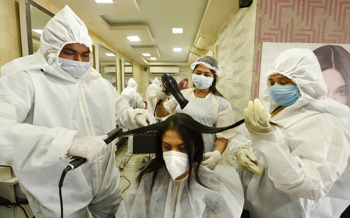  Beauticians wearing PPE kits attend a customer at a parlour that was opened during the fourth phase of COVID-19 lockdown, in Kolkata, Friday, May 29, 2020. (PTI Photo)