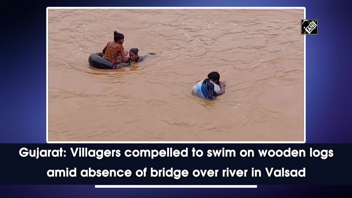 Gujarat Villagers compelled to swim on wooden logs amid absence of