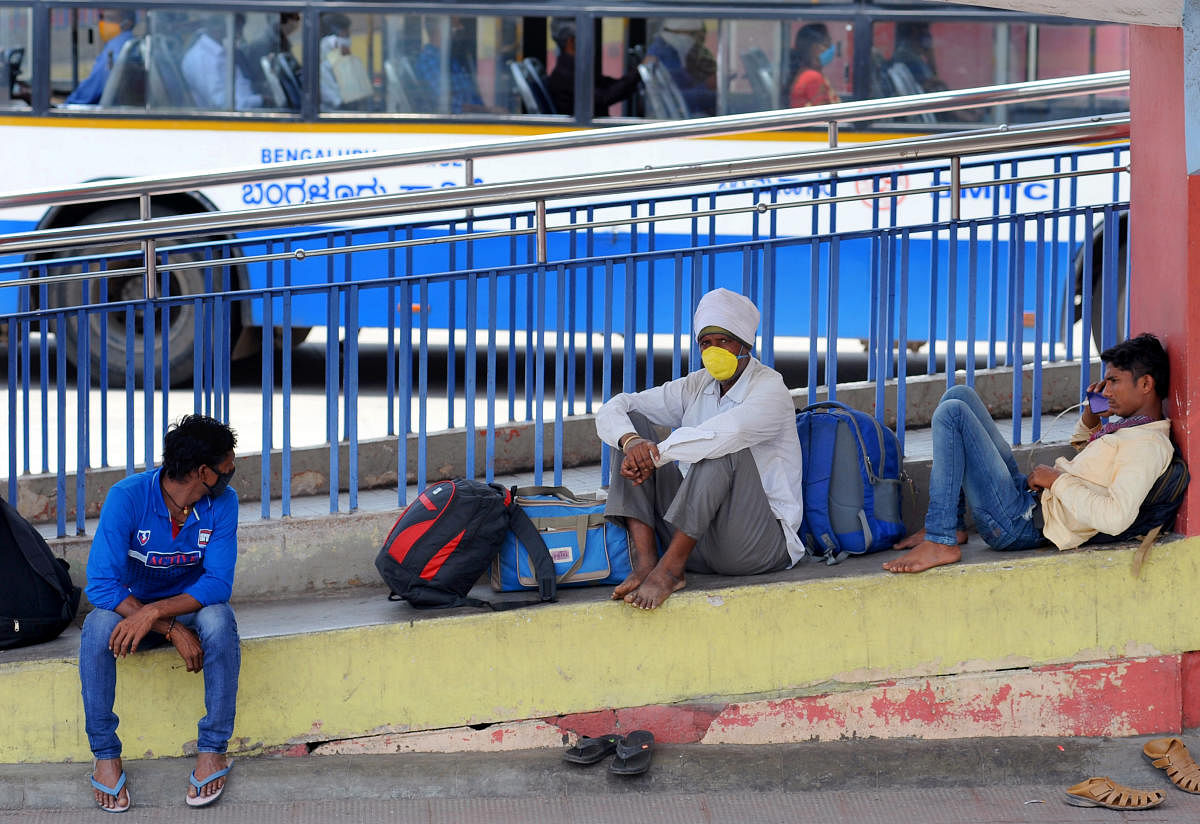 Passengers wait for buses at Majestic in Bengaluru on Friday. (DH Photo/Pushkar V)