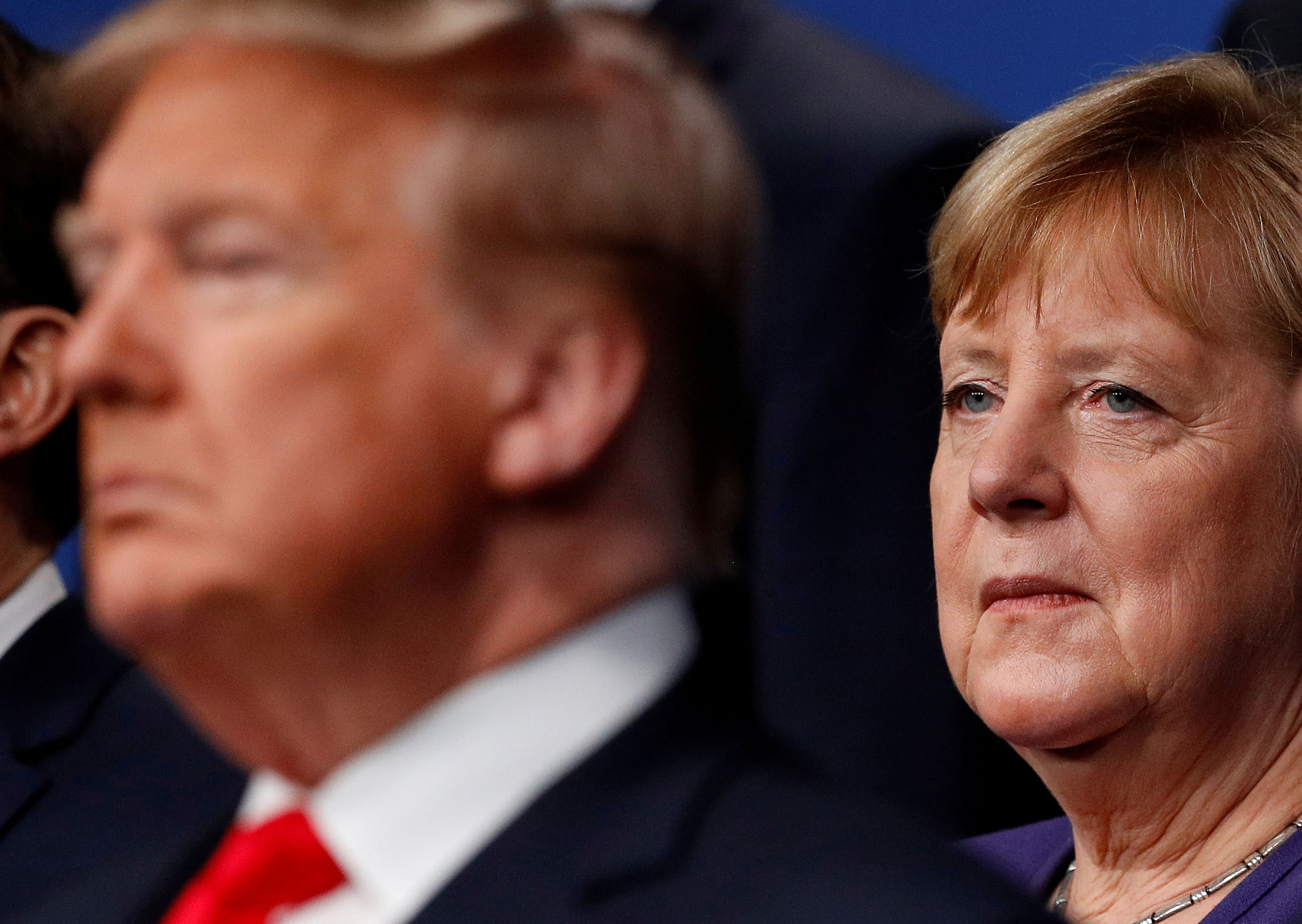 U.S. President Donald Trump and Germany's Chancellor Angela Merkel pose for the family photo during the annual NATO heads of government summit at the Grove Hotel in Watford, Britain. (Credit: Reuters photo)