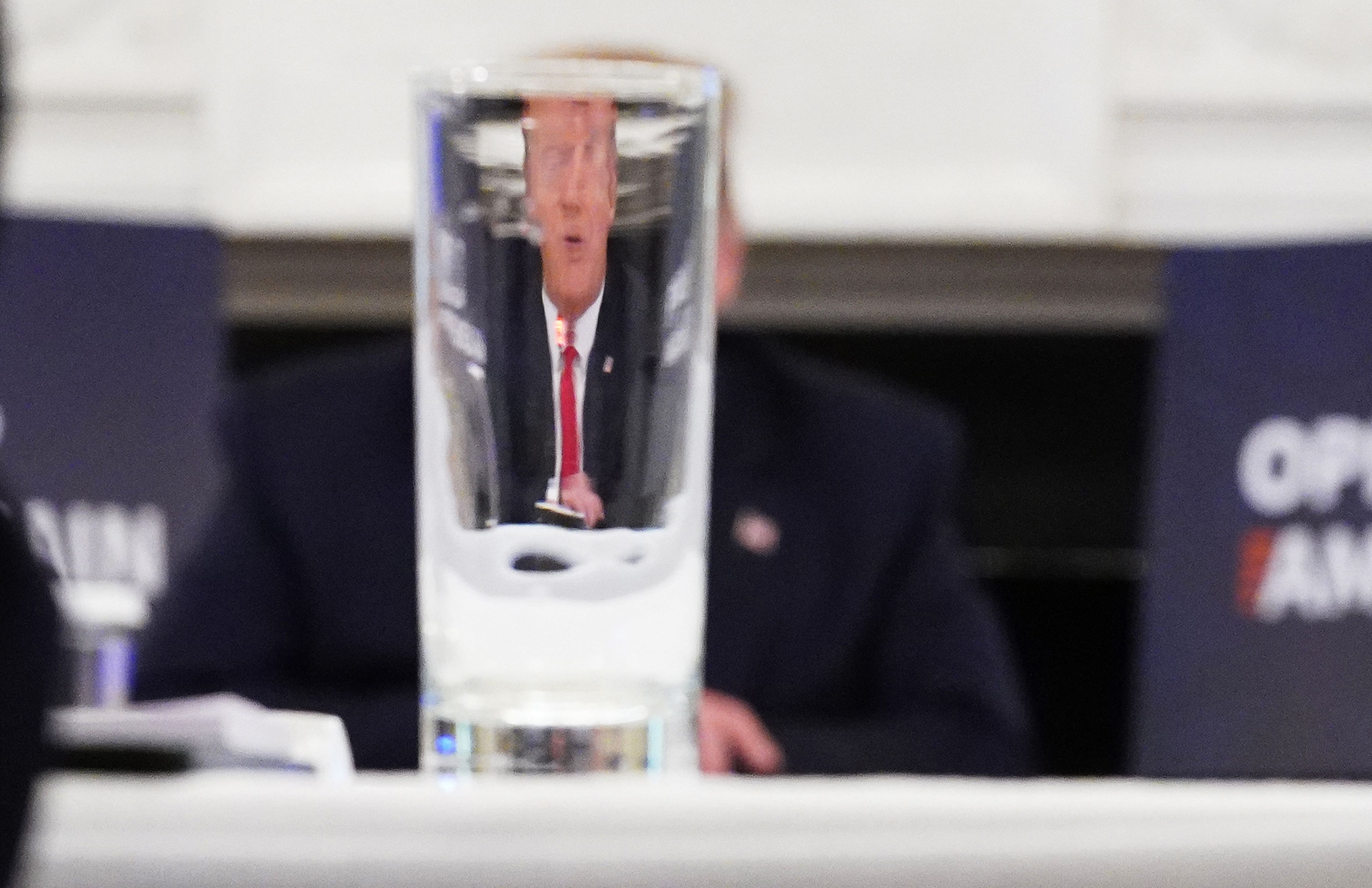 US President Donald Trump is seen through a drinking glass. (AFP Photo)